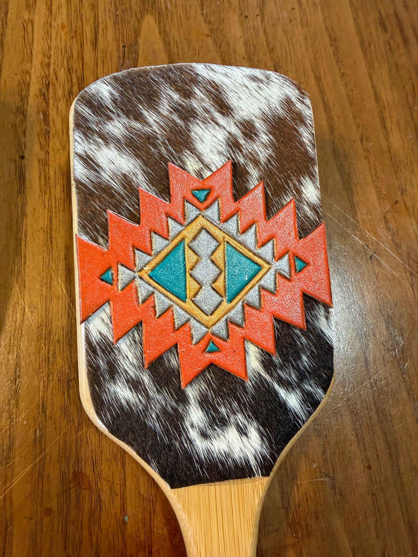 Hand tooled and cowhide hairbrush