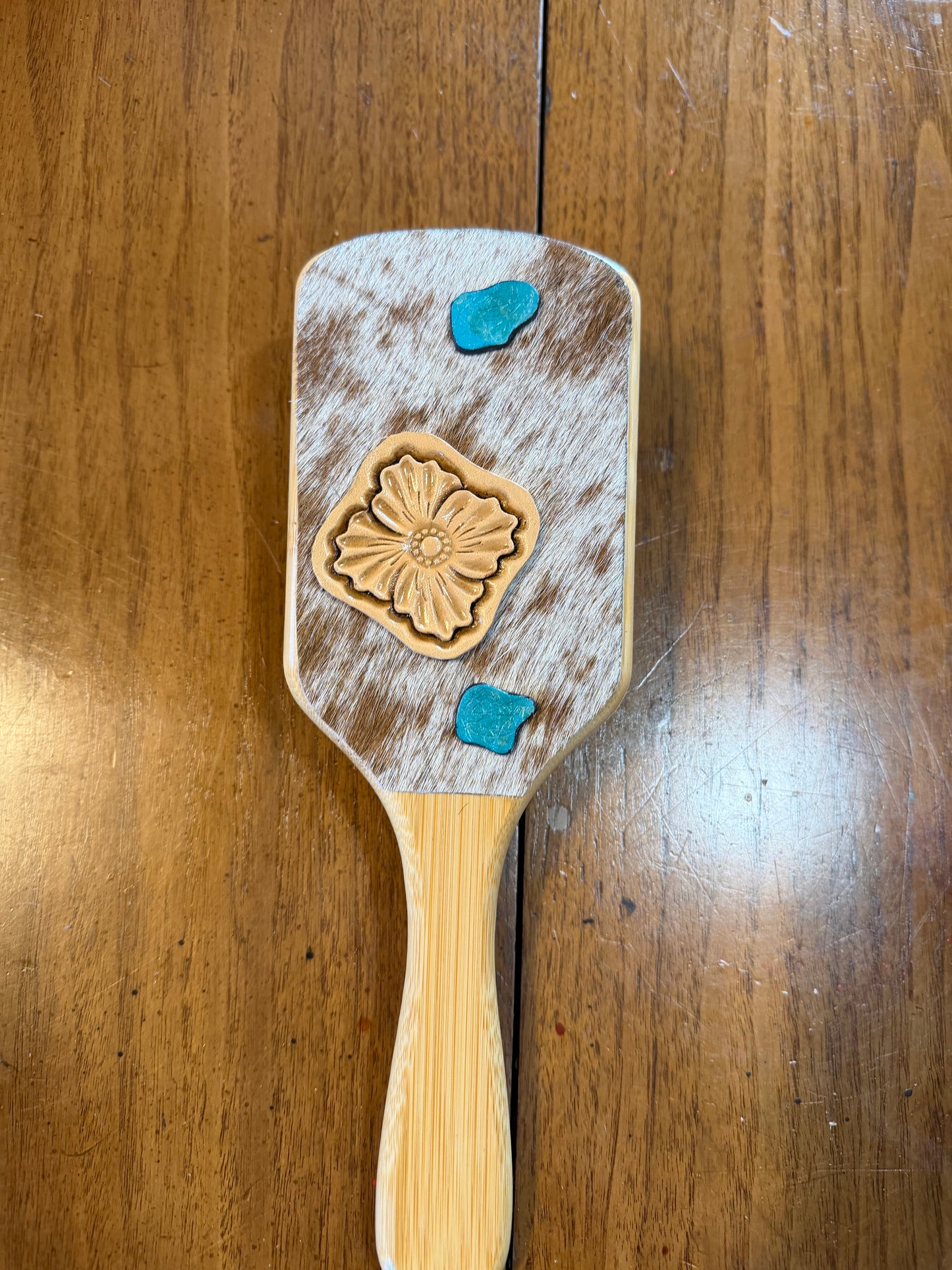 Hand tooled and cowhide hairbrush