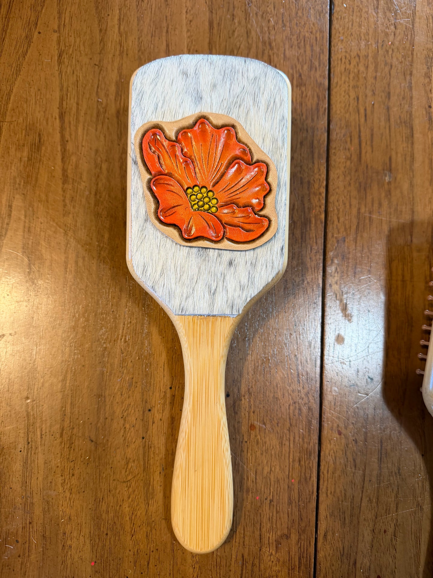 Hand tooled and cowhide hairbrush