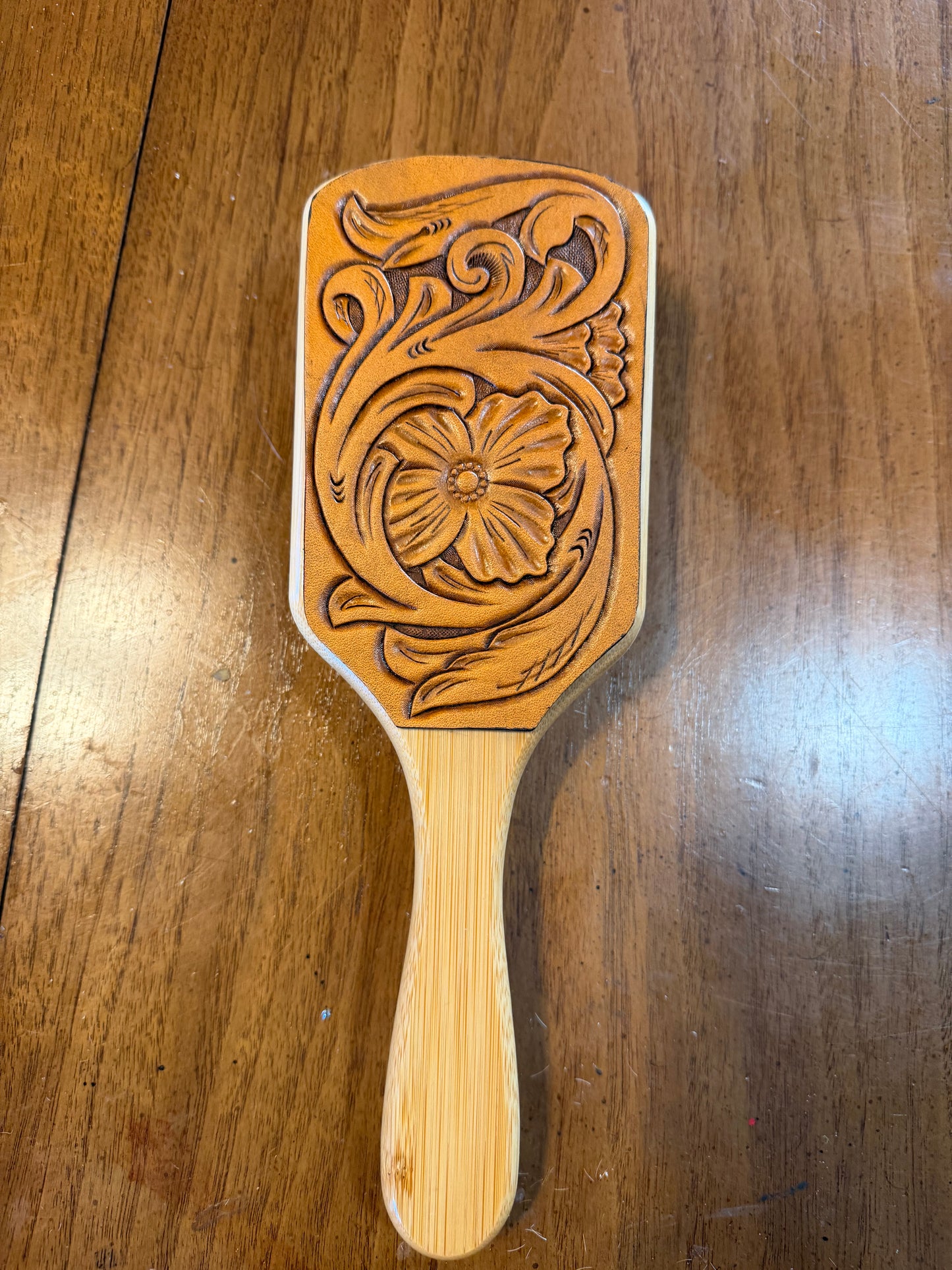 Hand tooled and cowhide hairbrush