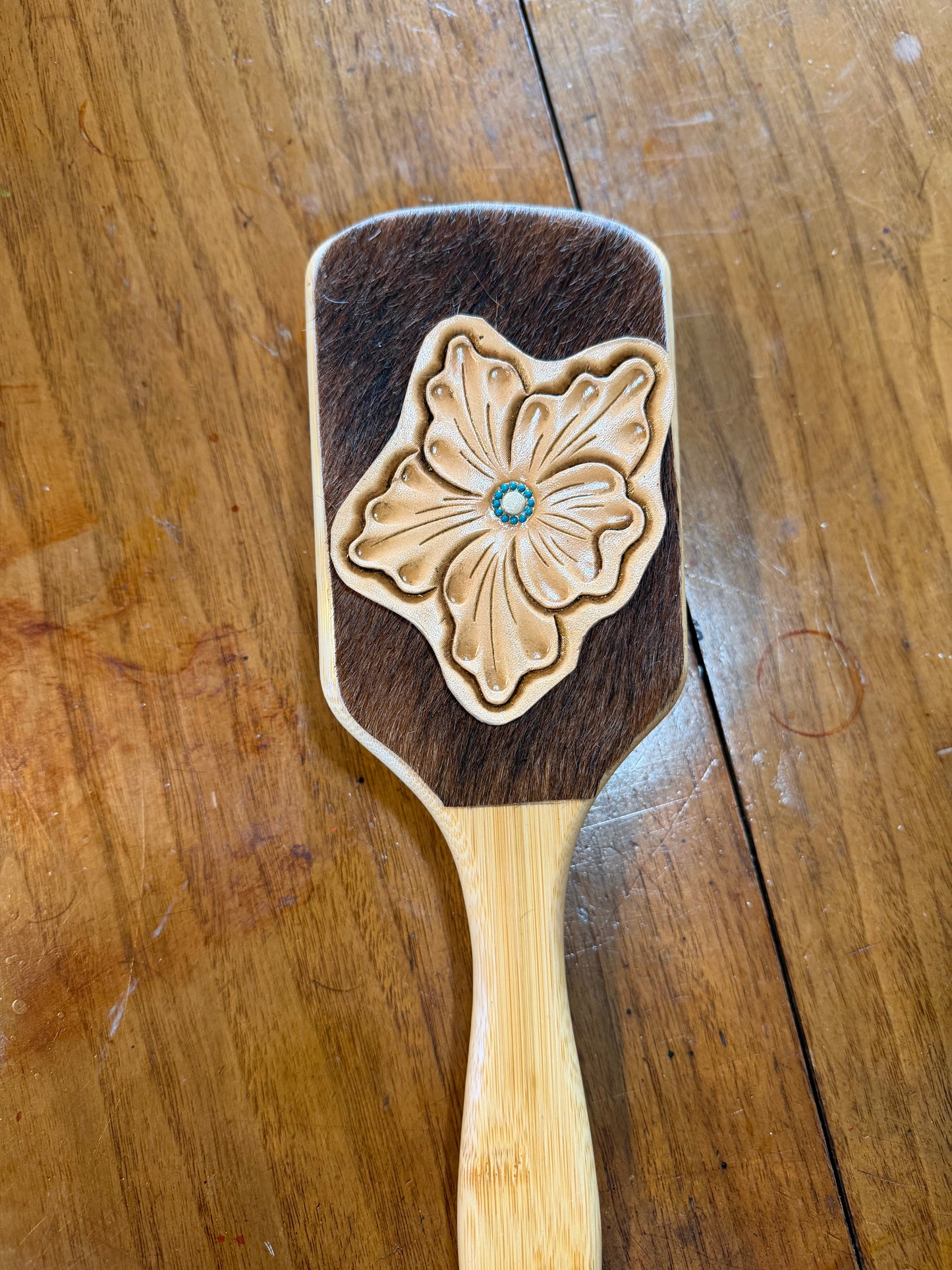 Hand tooled and cowhide hairbrush