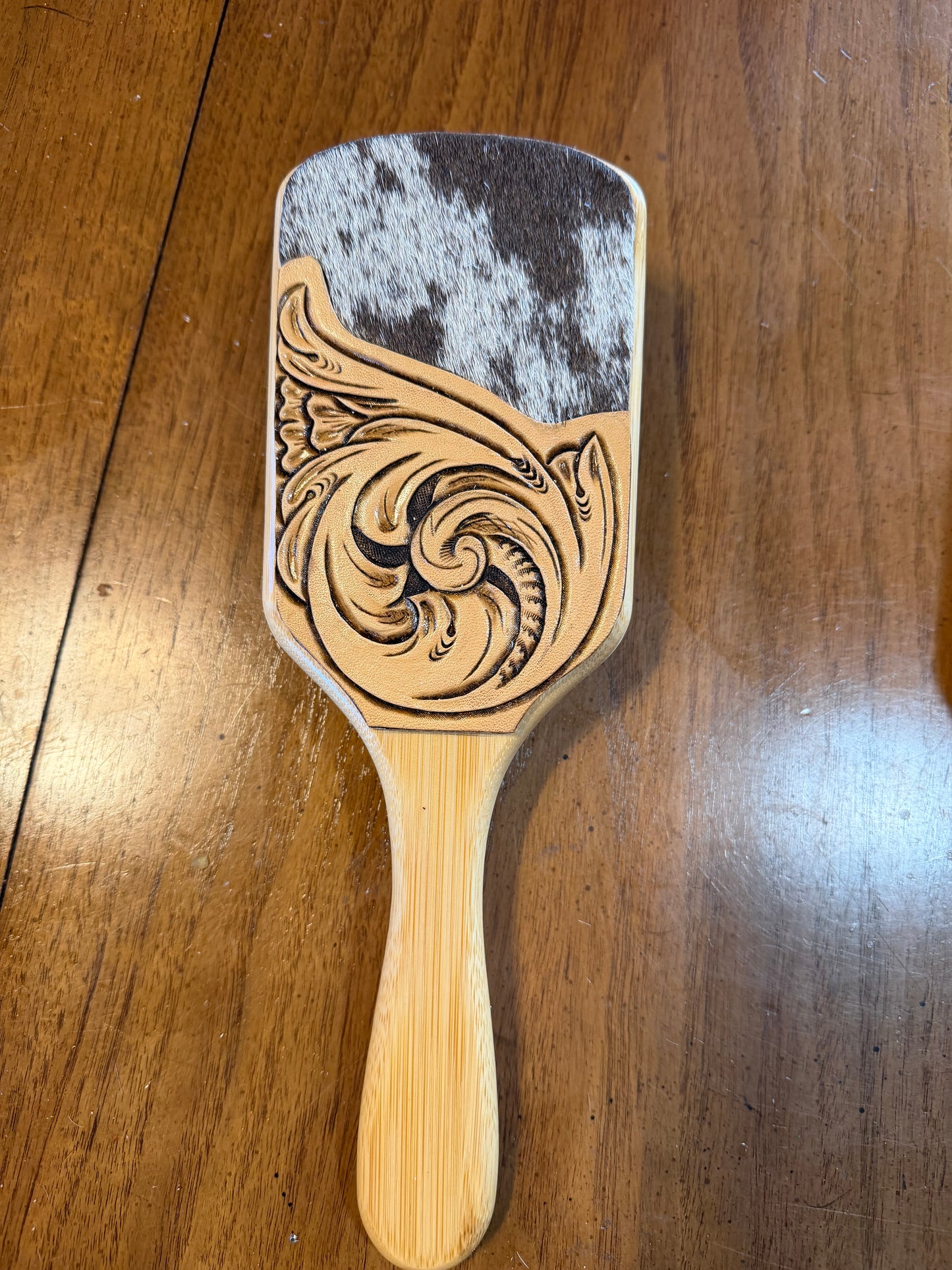 Hand tooled and cowhide hairbrush